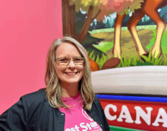lady wearing glasses with blonde hair and a pink shirt with the Best Start Logo on it