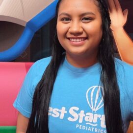 Young lady wearing a blue shirt that says Best Start Pediatrics